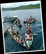Solomon Islanders in canoes